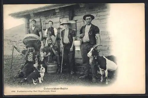 AK Unterwaldner-Aepler, Gruppe mit Ziege und Hund vor einer Berghütte