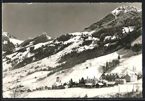 AK Melchtal, Ortsansicht gegen verschneite Berge