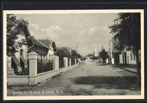 AK Parndorf, Strassenpartie mit Kirche