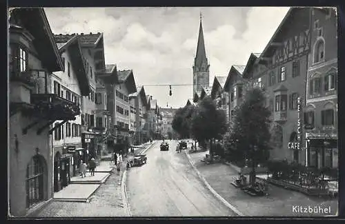 AK Kitzbühel, Strassenpartie mit Cafe Reisch, Geschäften und Kirche