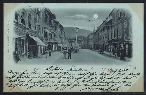 Mondschein-AK Villach, Strassenpartie am Platz bei Nacht