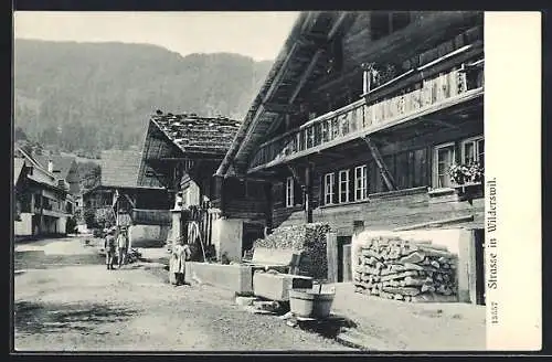 AK Wilderswil, Strassenpartie mit Holzhäusern