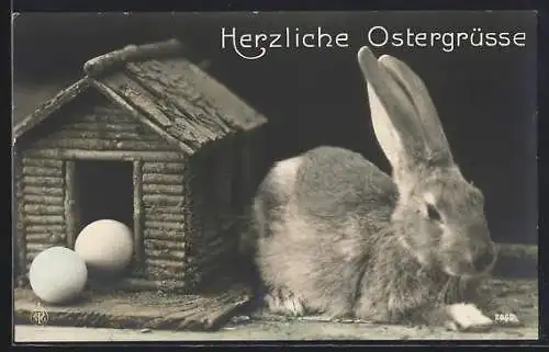 AK Osterhase neben Holzhütte und Ostereiern