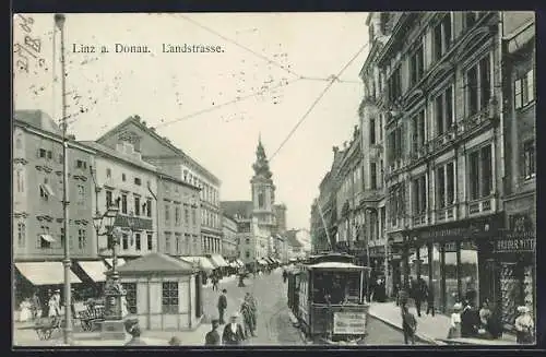 AK Linz a. Donau, Landstrasse mit Strassenbahn und Turmgebäude