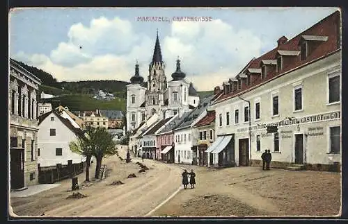 AK Mariazell, Grazergasse mit Blick auf Gasthof zur Gold. Kanone, Häuserzeile und Kirche