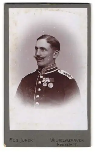 Fotografie Aug. Junck, Wilhelmshaven, Seebataillon Uffz. Rudolf in uniform mit Ordenband & Gefechtsspange