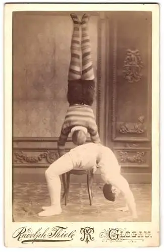 Fotografie Rudolph Thiele, Glogau, zwei polnische Akrobaten / Turner, Handstand und Brücke, Kostüm