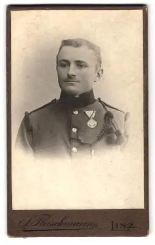 Fotografie S. Fleischmann, Linz, K.u.K. Soldat in Uniform mit Orden und Schützenschnur