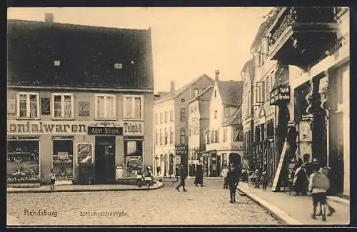 AK Rendsburg, Schleifmühlenstrasse mit Kolonialwarenhandlung A. Schramm