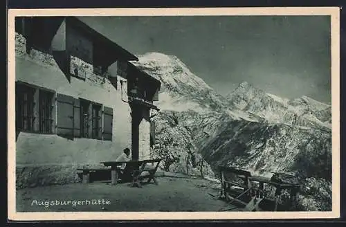 AK Augsburger Hütte, Mann an einem Tisch vor der Hütte