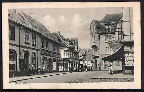 AK Rendsburg, Stegenstrasse mit Colonialwarenhandlung und anderen Geschäften