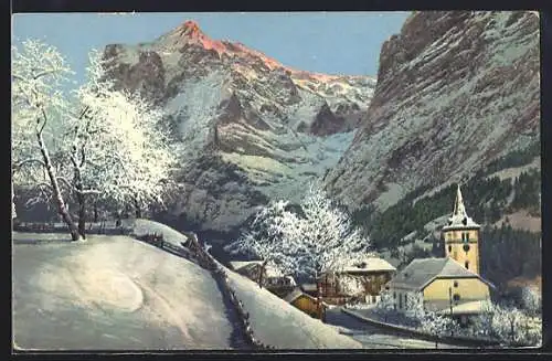 AK Grindelwald, Winterliche Ortsansicht mit Schneebedeckter Kirche und Blick auf das Wetterhorn