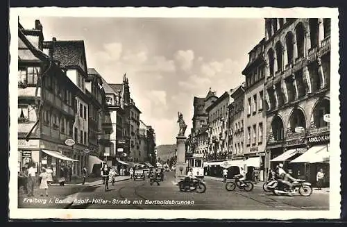 AK Freiburg i. Br., Strasse mit Geschäften, Bertholdsbrunnen und Strassenbahn