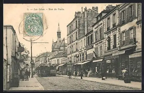 AK Les Lilas, Rue de Paris, Strassenpartie mit Strassenbahn