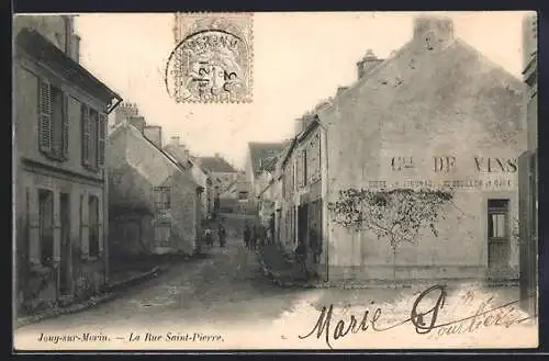 AK Jouy-sur-Morin, La Rue Saint-Pierre et le mur publicitaire pour le vin