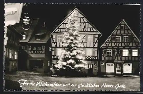 AK Gernsbach im Murgtal, Strassenpartie mit Friseursalon Herzog und Tannenbaum bei Nacht, Festtagsgruss