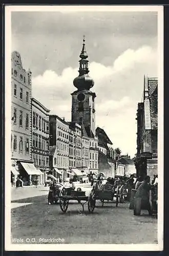 AK Wels, Strassenpartie mit Einhorn Apotheke, weiteren Geschäften und Pfarrkirche