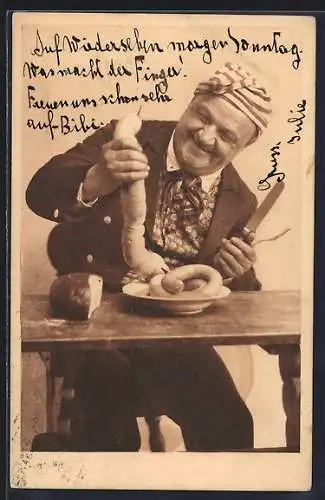 AK Mann mit Brot und Würsten am Tisch