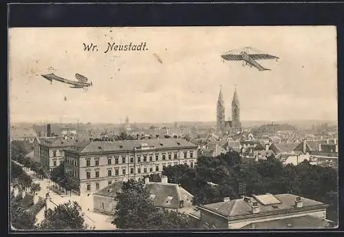 AK Wr. Neustadt, Totalansicht mit Strasse und Flugzeug aus der Vogelschau