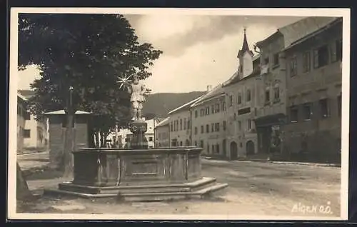 AK Aigen, Strassenpartie mit Brunnen