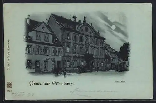 Mondschein-AK Offenburg, Strassenpartie mit Geschäft und Rathaus