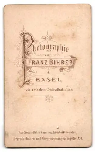 Fotografie Franz Bihrer, Basel, Schulknabe mit Ranzen auf Schaukelpferd - Dreirad