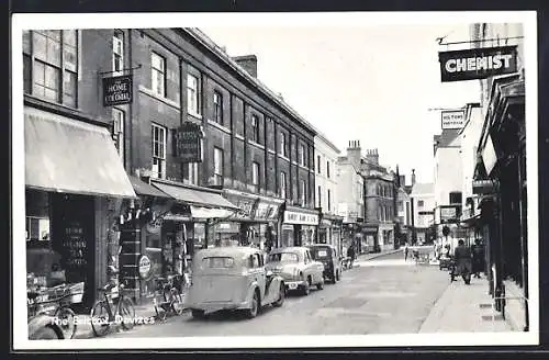 AK Devizes, the Brittox, view taken in front of the chemist, cars and bicycles on the street