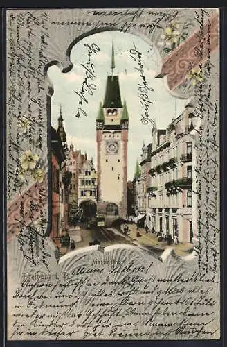 AK Freiburg i. B., Martinsthor mit Strassenbahn, Blumen-Passepartout
