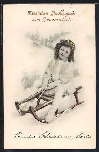 AK Kind auf einem Schlitten im Winter, Neujahrsgruss