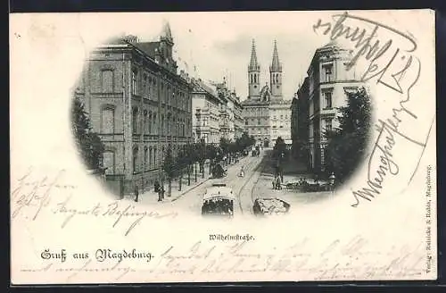 AK Magdeburg, Die Wilhelmstrasse mit Strassenbahn und Blick auf die Kirche