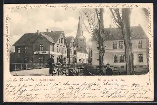 AK Bünde, Bahnhofstrasse mit Geschäft von G. Hotfilter und Kirche