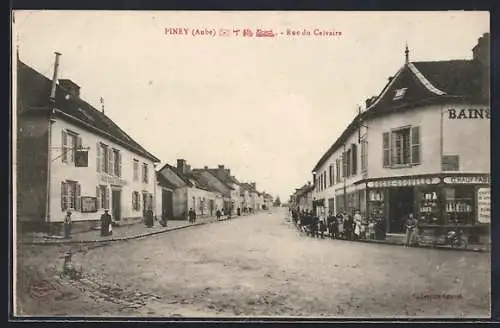 AK Piney, Rue du Calvaire avec commerces et passants