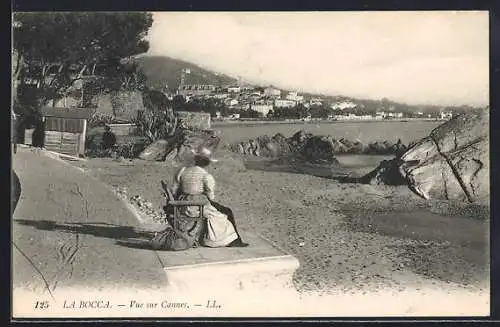 AK La Bocca, Vue sur Cannes avec une femme assise au bord de la mer