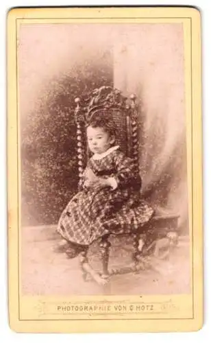 Fotografie Gustav Hotz, Stockach, Kleinkind auf kunstvollem Stuhl
