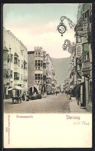 AK Sterzing, Strassenpartie mit Geschäften, um 1900
