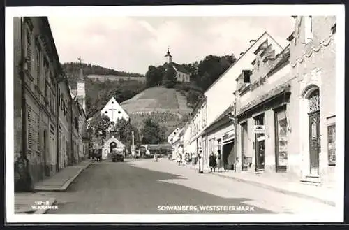 AK Schwanberg /Weststeiermark, Strassenpartie mit Geschäft Gottfried Mayer u. Kirchen