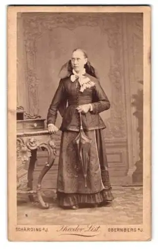 Fotografie Theodor List, Schärding am Inn, Schlossgasse 5, Dame in Tracht mit Schirm