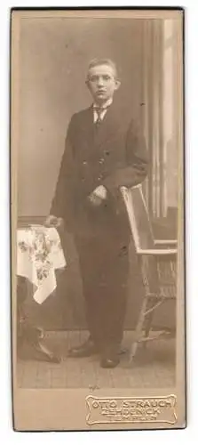Fotografie Otto Strauch, Zehdenick, Am Markt 1, Eleganter junger Mann neben Tisch stehend