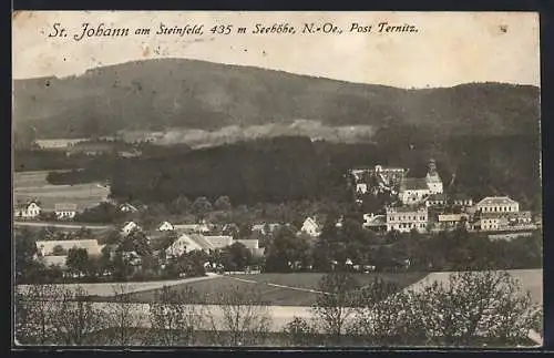 AK St. Johann am Steinfeld, Ortsansicht mit Berglandschaft