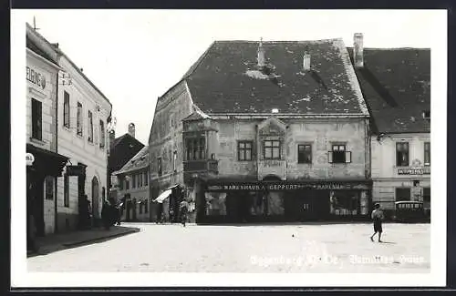 AK Eggenburg /N.-Oe., Bemaltes Haus mit Geschäft A. Geppart, Autowerkstatt, Tanksäule Shell