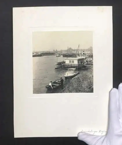 Fotografie unbekannter Fotograf, Ansicht Duisburg, Blick in den Hafen mit Ruderboot und Frachtschiffen, Rheinbrücke, 193