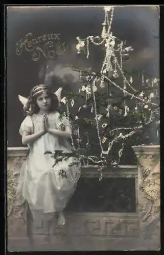 AK Betender Weihnachtsengel vor einem Tannenbaum