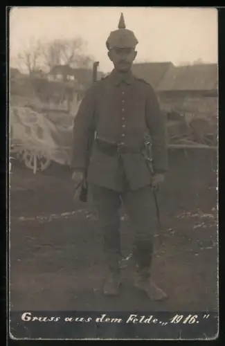 Foto-AK Soldat in Feldgrau Uniform mit Bajonett und Gewehr, Pickelhaube mit Tarnbezug