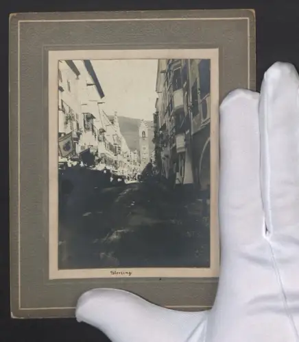 Fotografie unbekannter Fotograf, Ansicht Sterzing, Strassenpartie mit Blick zum Zwölferturm und Geschäften
