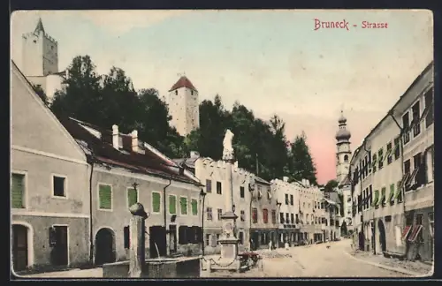 AK Bruneck, Strassenpartie mit Denkmal und Brunnen