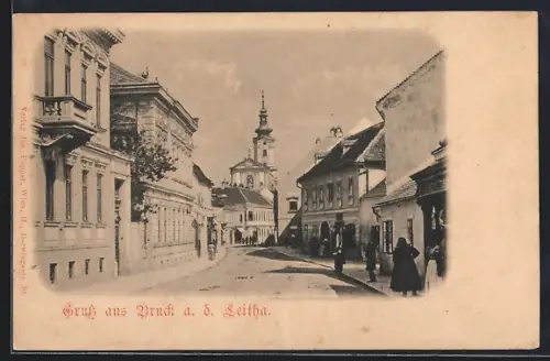 AK Bruck a. d. Leitha, Strassenpartie mit Kirche