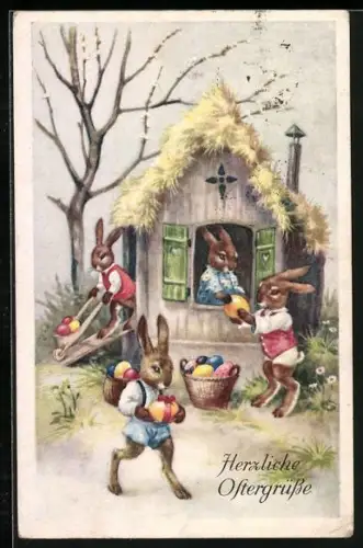 Künstler-AK Osterhasen laden Ostereier in einen Korb, Herzliche Ostergrüsse