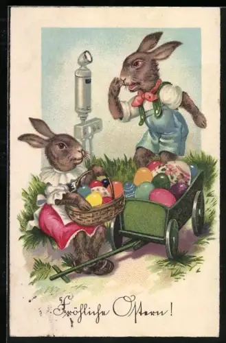 Künstler-AK Osterhasenpaar mit bunten Eiern auf einer Wiese, Fröhliche Ostern
