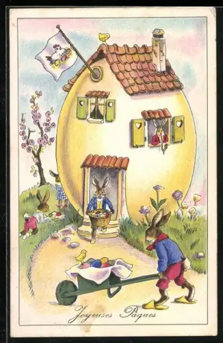 Künstler-AK Osterhasen tragen Ostereier vor ihrem Haus, Joyeuses Paques