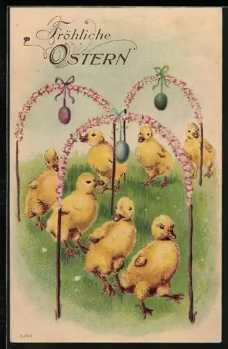 Künstler-AK Osterküken Entenküken laufen durch unter Blütenbögen auf einer Wiese, Fröhliche Ostern